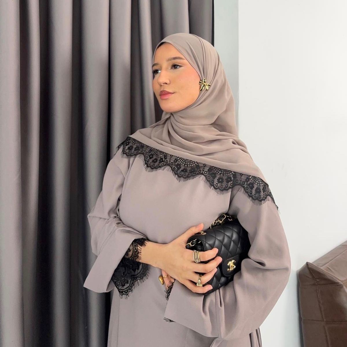 Model in a mauve lace-trimmed maxi dress with matching hijab