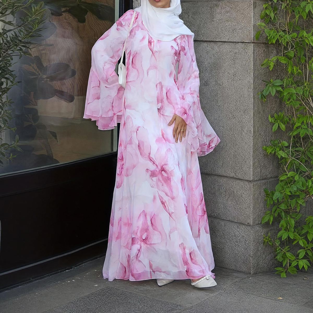 Model in a white printed maxi dress with bell sleeves