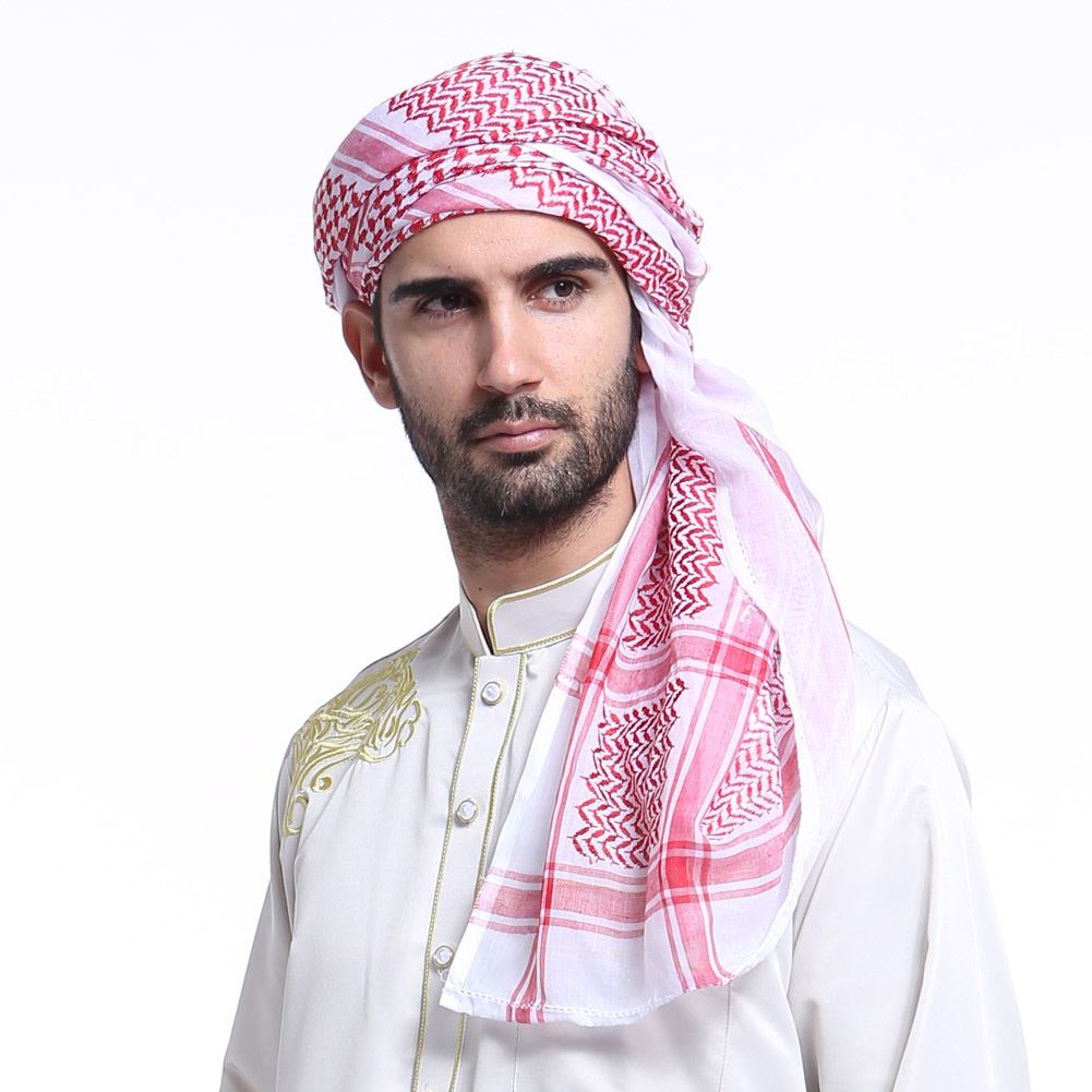 Man wearing a red and white checked headscarf with a gold-embroidered robe