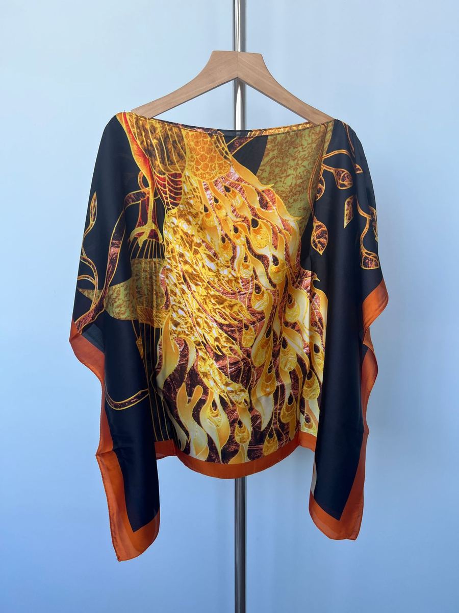 Faux-silk printed hijab scarf hanging on a wooden hanger, orange edge with floral pattern photo 3